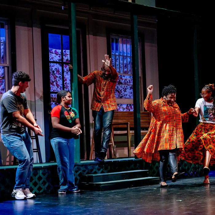 The company dancing together on the porch, elders and young people side by side