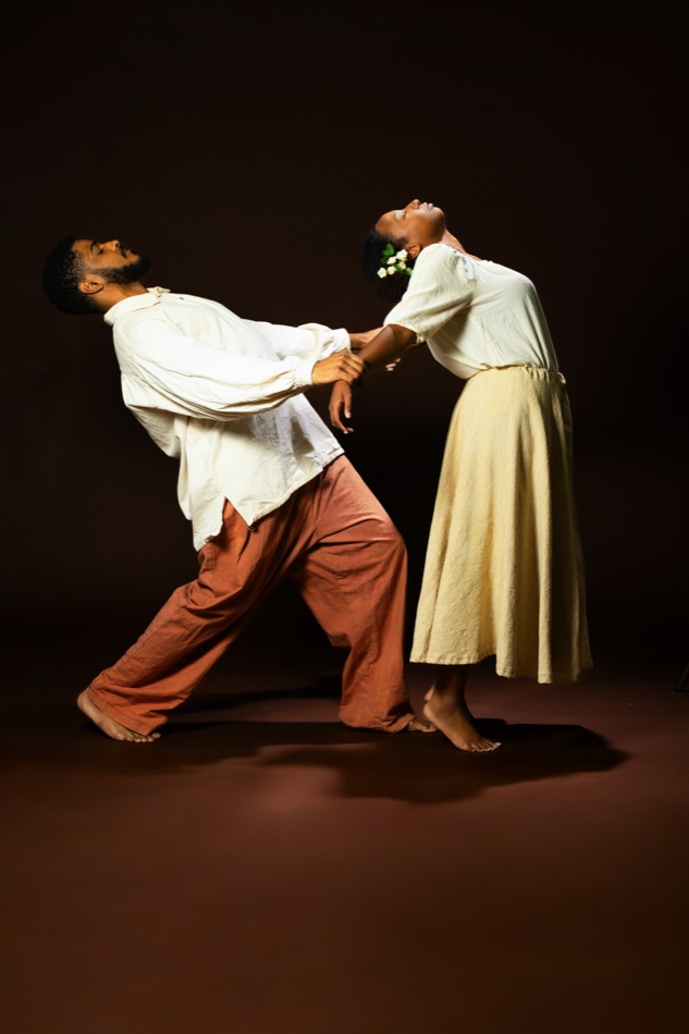 Two performers pulling apart in motion