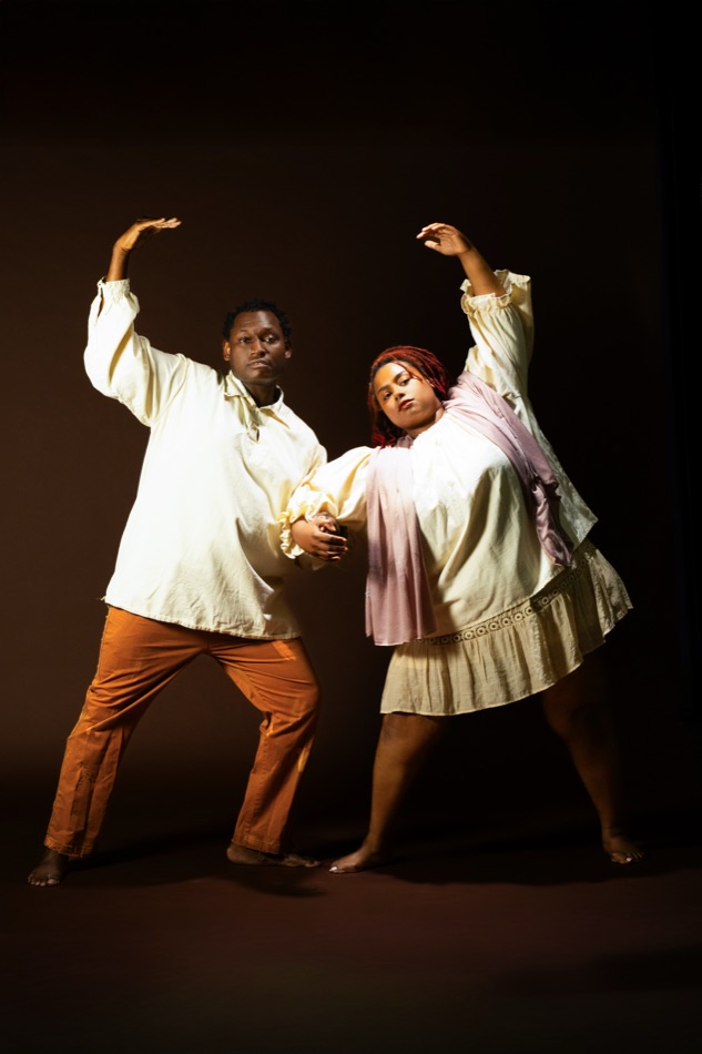 A couple with arms raised in a turning duet